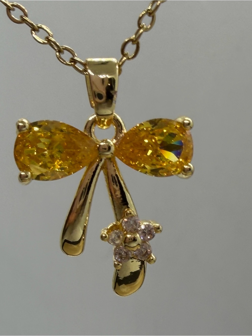 Gold Bow Pendant Necklace with Yellow Gemstones